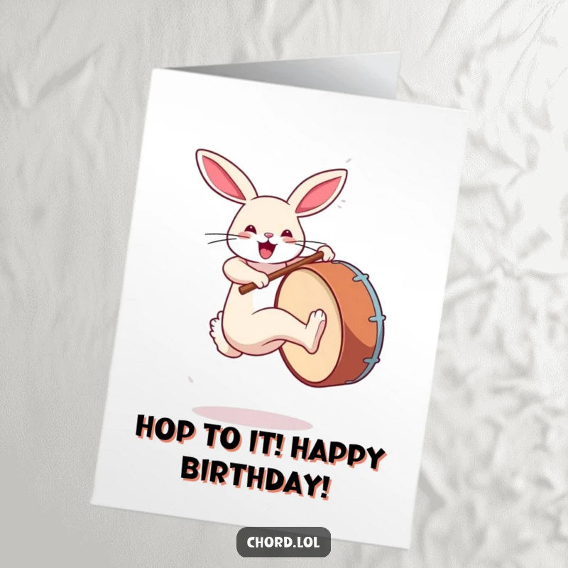 Funny Free Printable Birthday Card: Rabbit jumping, kicking a large bass drum, celebrating with rhythm.